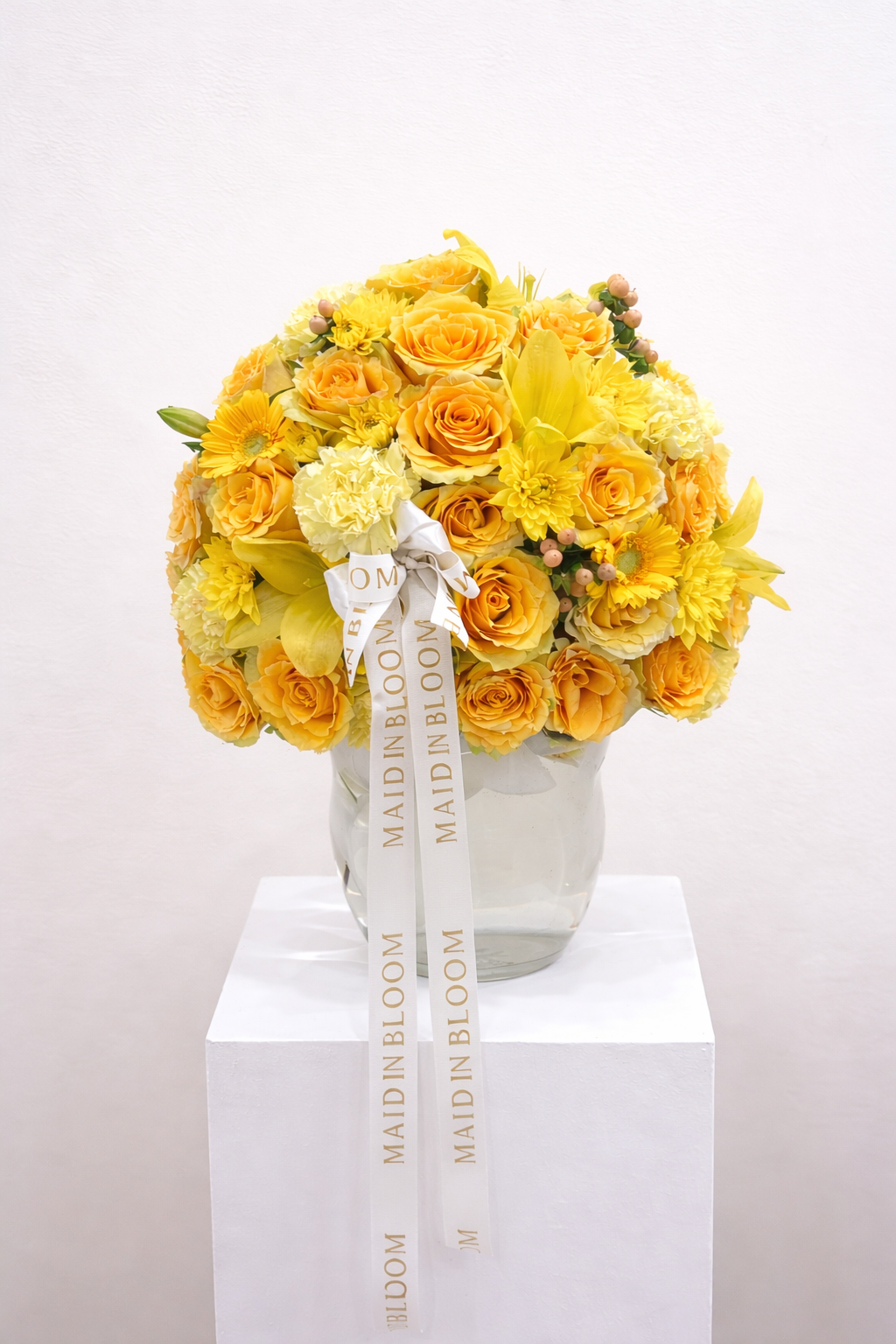 Bouquet of yellow flowers with a visible brand name on a white background